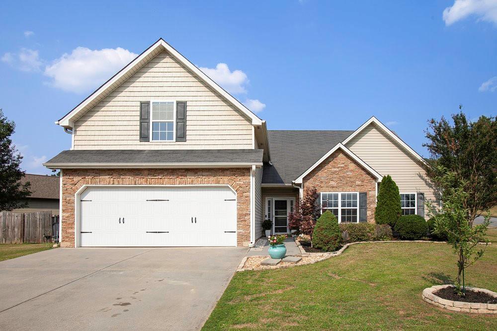 a view of a house with a yard and garage