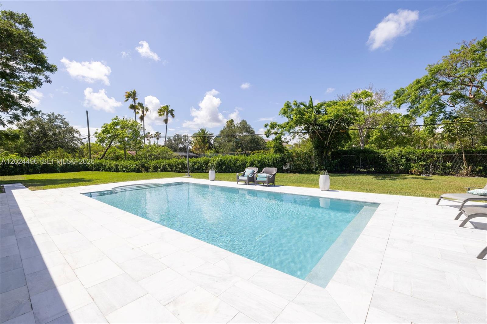 6875 North Cartee Road Palmetto Bay, FL 33158 - Photo 32 of 42 a view of a swimming pool and a yard