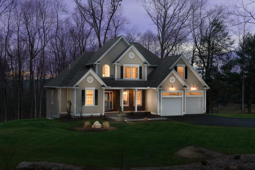 a front view of a house with a garden and yard