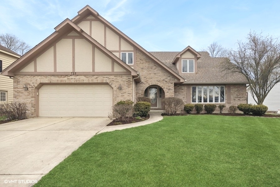 725 Chesterfield Avenue Naperville, IL 60540 - Photo 1 of 26 a front view of a house with a yard and garage