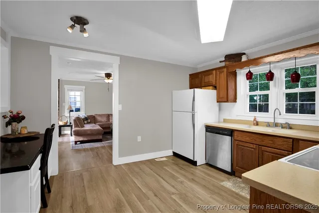a view of kitchen with cabinets and wooden floor