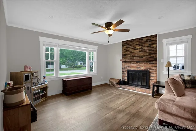 a living room with furniture a fireplace and a flat screen tv