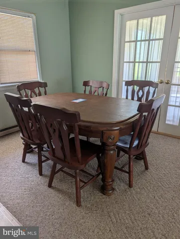 a view of a dining room with furniture and window