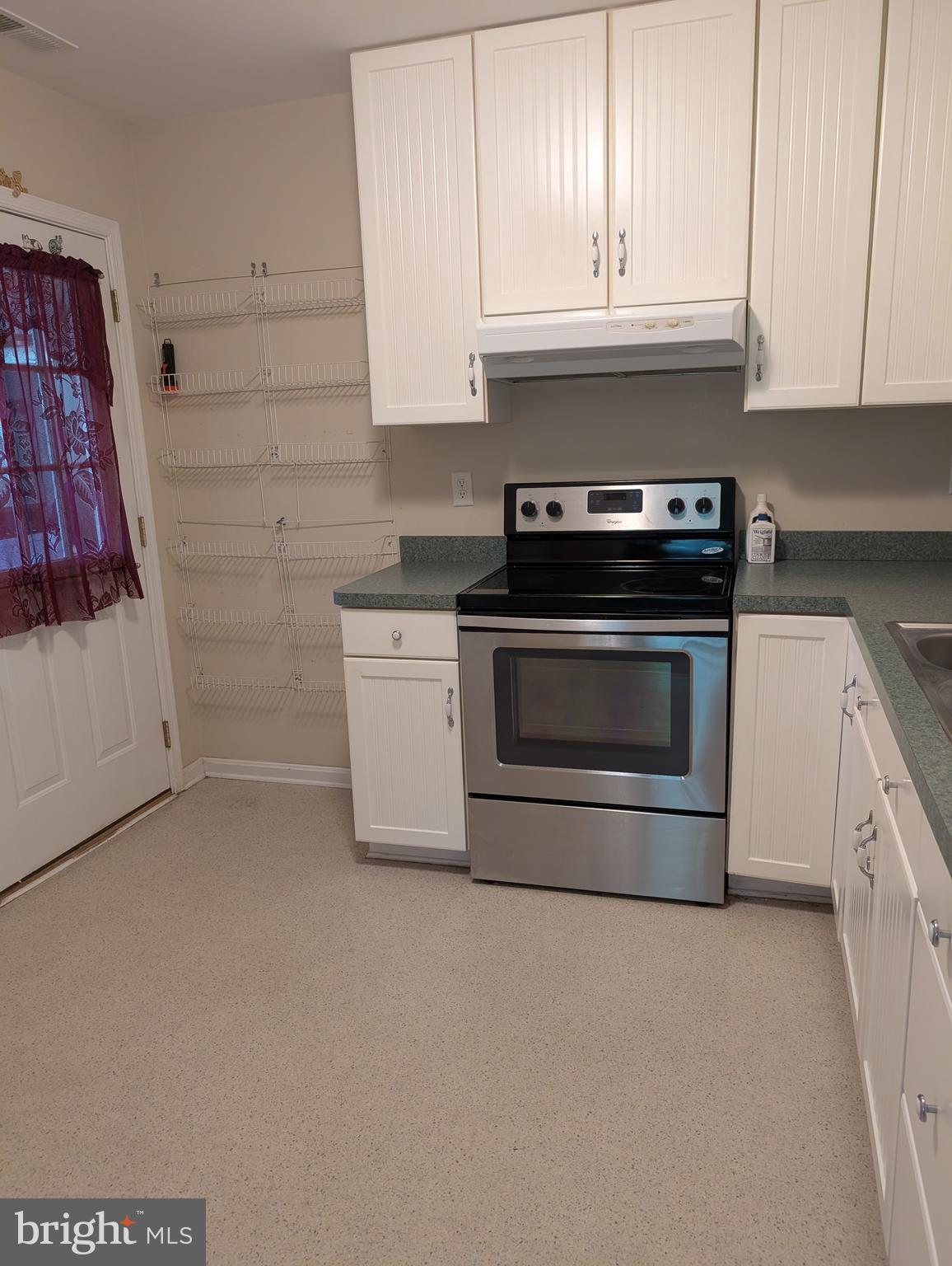 12615 Eveland Road Ridgely, MD 21660 - Photo 18 of 28 a kitchen with granite countertop white cabinets and appliances