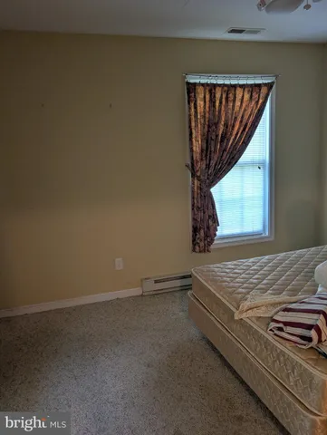 a view of a room with exposed radiator and window