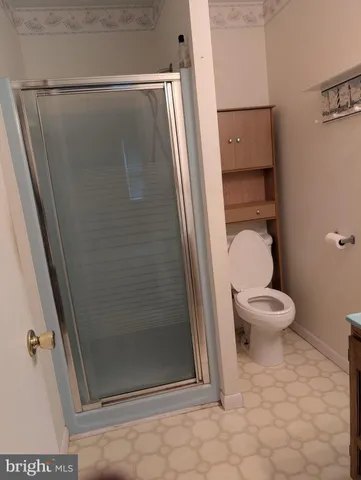 a bathroom with a toilet and a shower