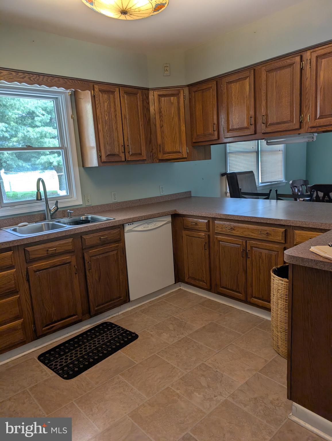 12615 Eveland Road Ridgely, MD 21660 - Photo 10 of 28 a kitchen with a sink a stove a window cabinets and a window