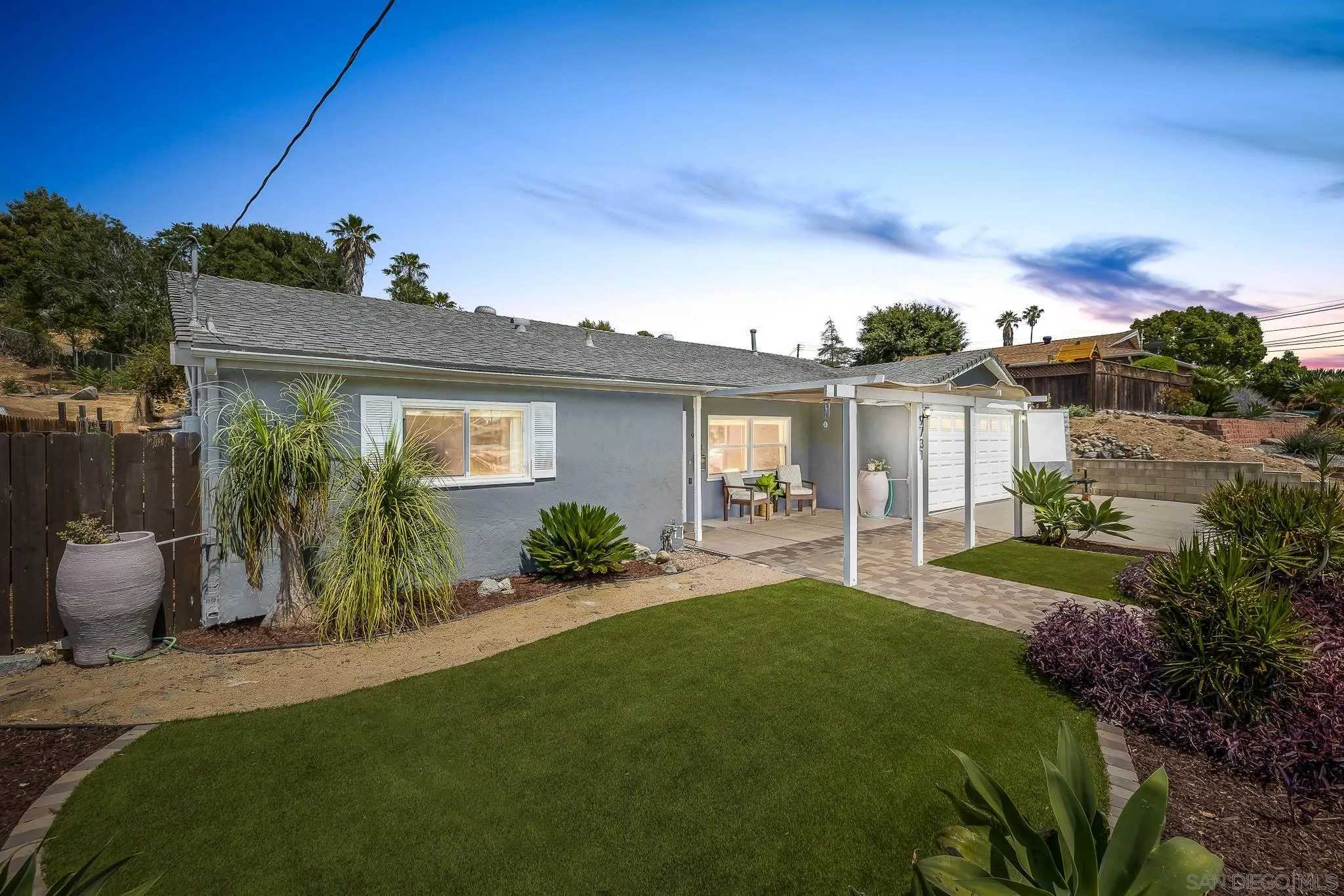 9731 Domer Road Santee, CA 92071 - Photo 1 of 32 a front view of a house with a garden