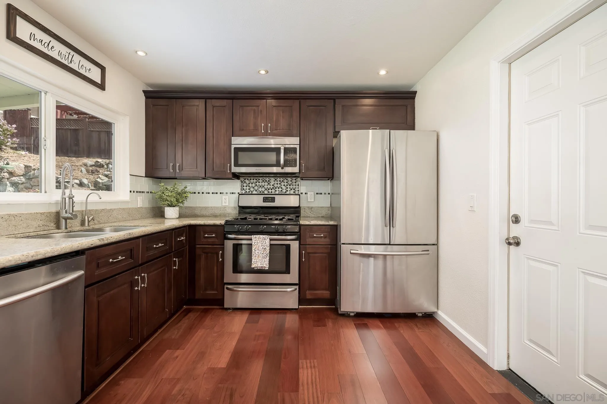 9731 Domer Road Santee, CA 92071 - Photo 12 of 32 a kitchen with a refrigerator stove and sink