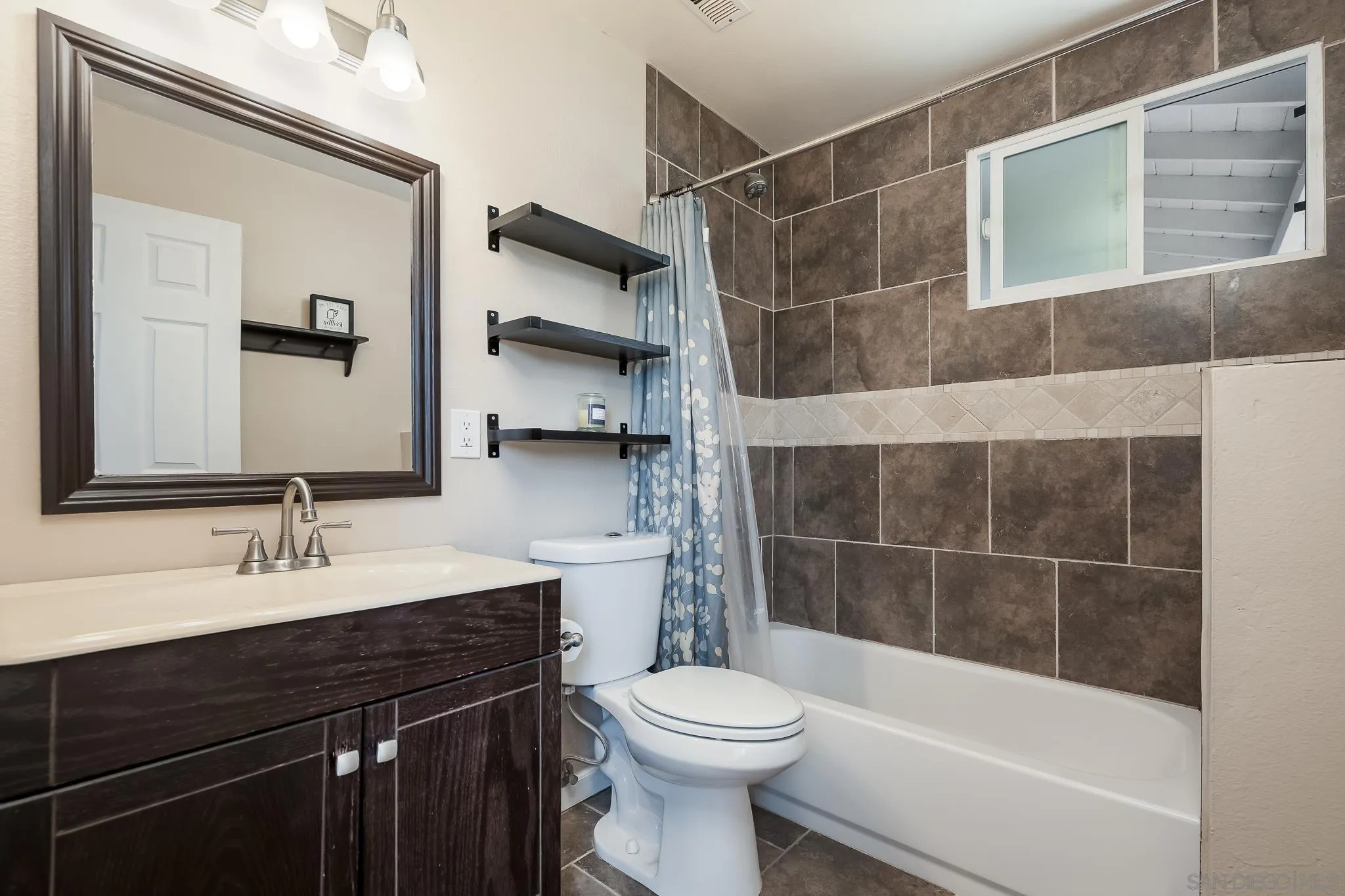 9731 Domer Road Santee, CA 92071 - Photo 17 of 32 a bathroom with a sink a toilet and shower