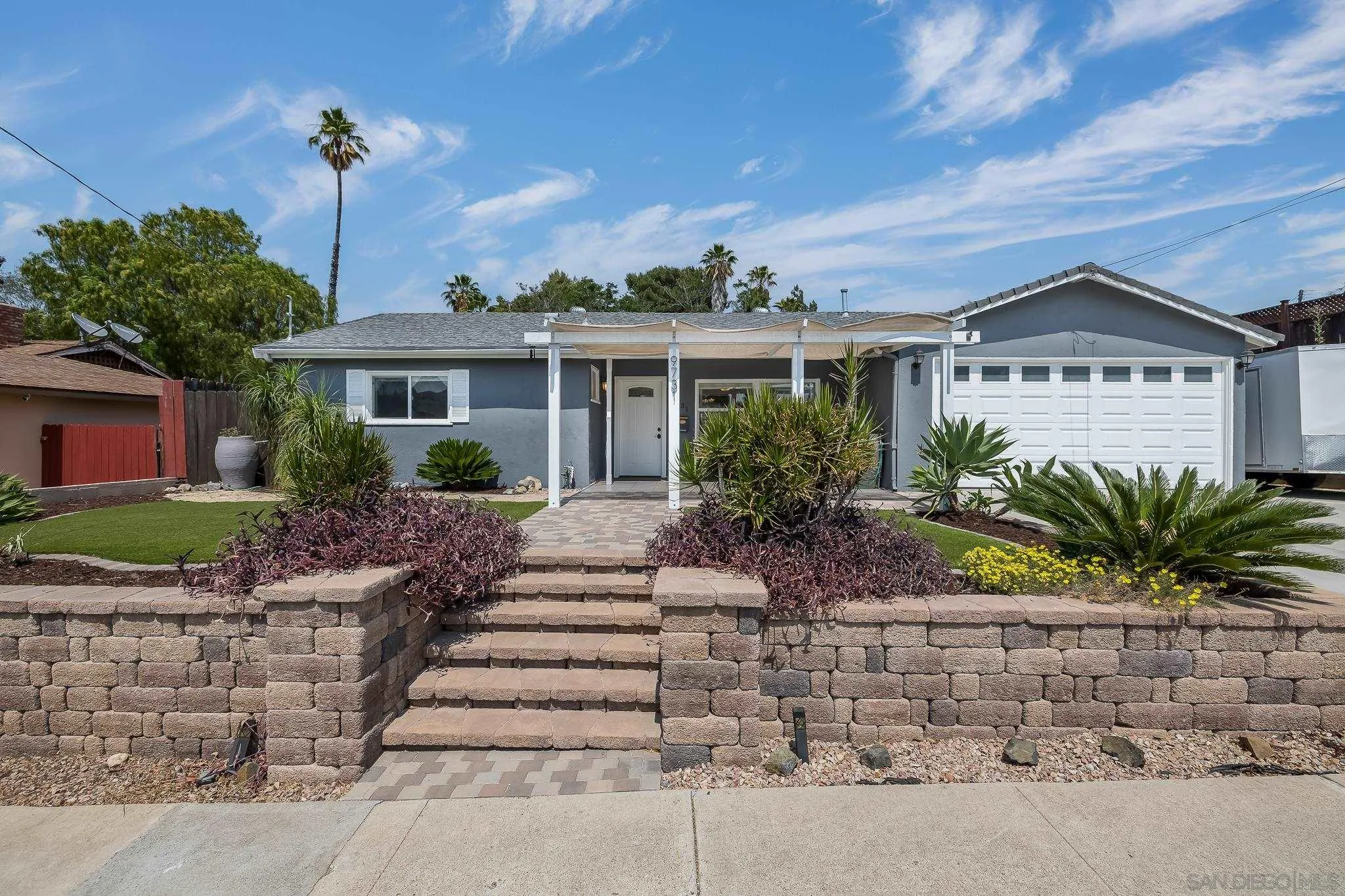 9731 Domer Road Santee, CA 92071 - Photo 2 of 32 a front view of a house with a garden