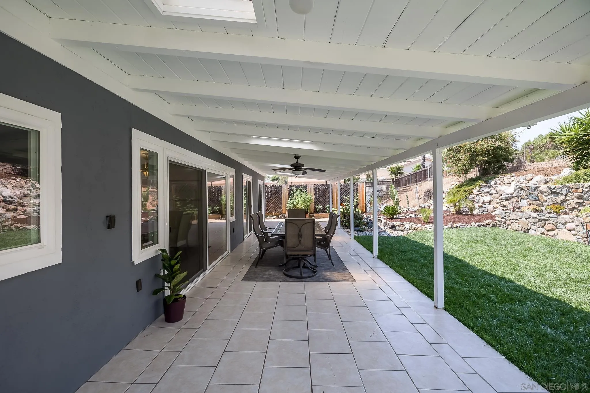9731 Domer Road Santee, CA 92071 - Photo 22 of 32 a view of a patio with table and chairs potted plants with floor to ceiling window