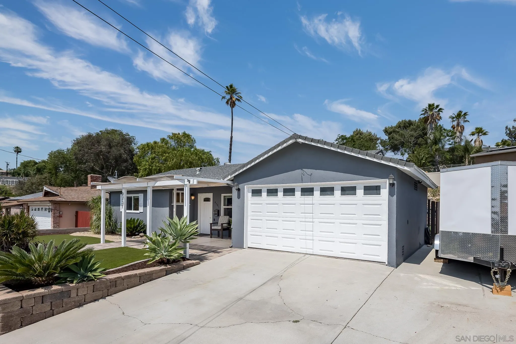 9731 Domer Road Santee, CA 92071 - Photo 3 of 32 a front view of a house with a yard and potted plants