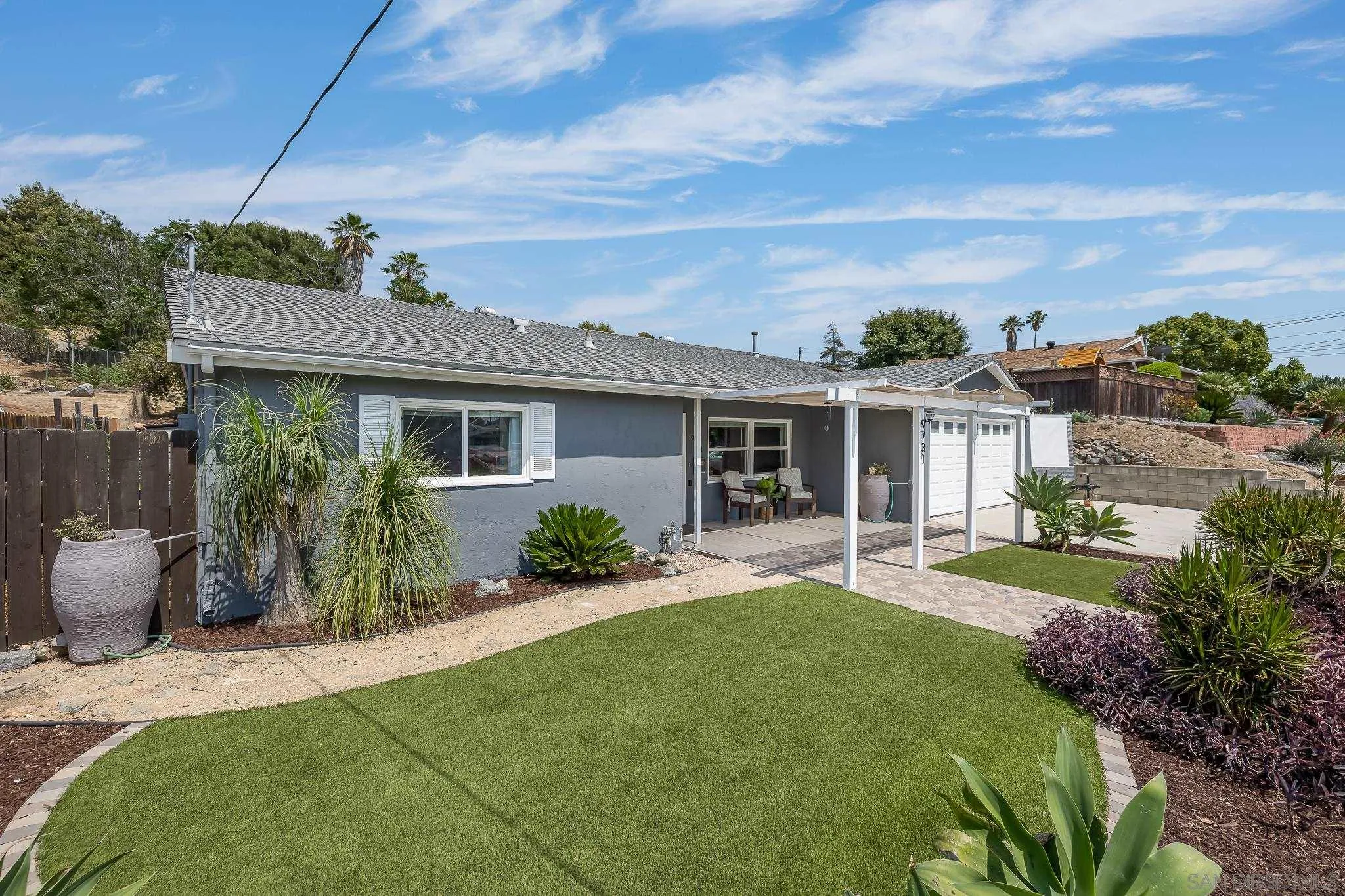 9731 Domer Road Santee, CA 92071 - Photo 4 of 32 a front view of a house with a yard