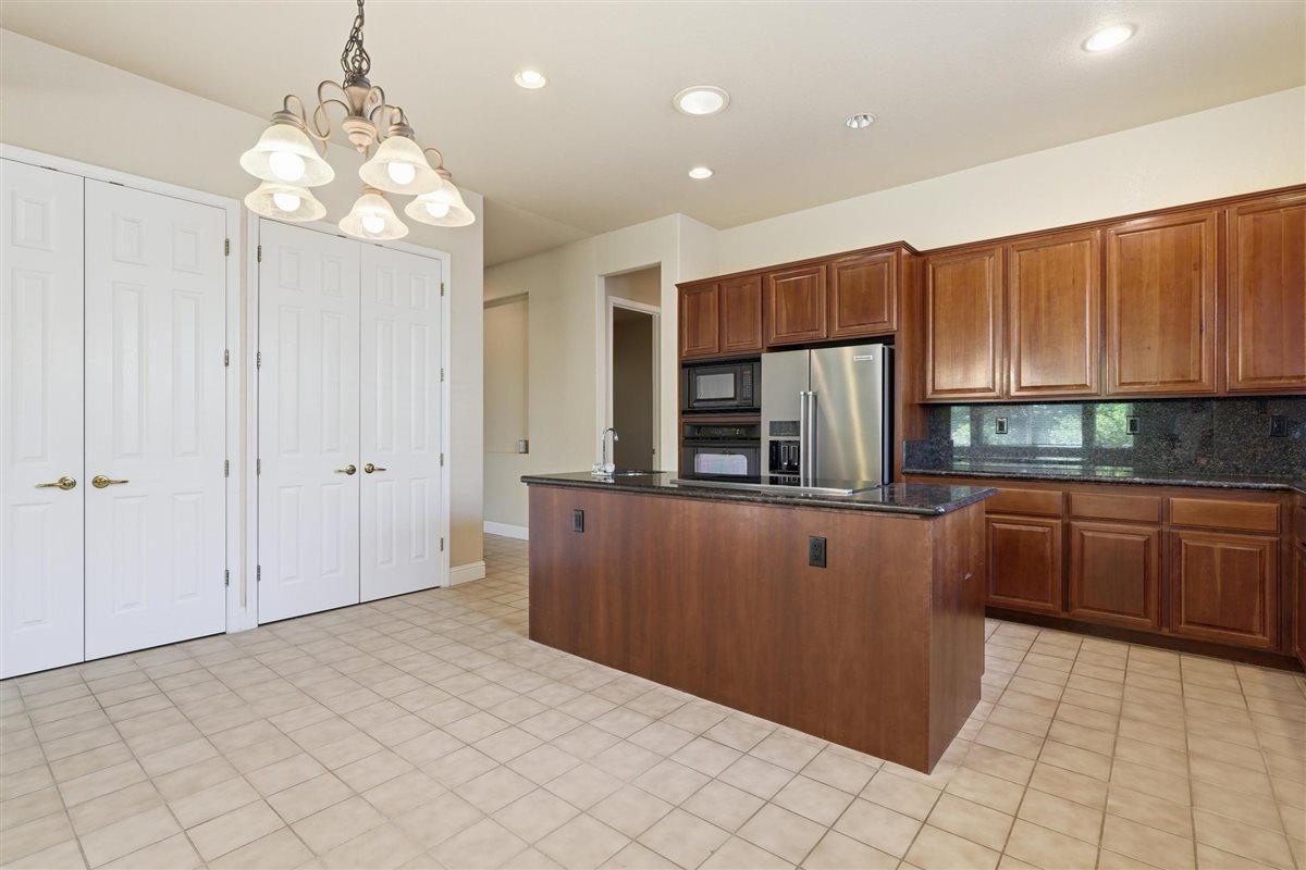 4129 Poppleton Way Carmichael, CA 95608 - Photo 14 of 48 a kitchen with stainless steel appliances granite countertop a refrigerator and a sink