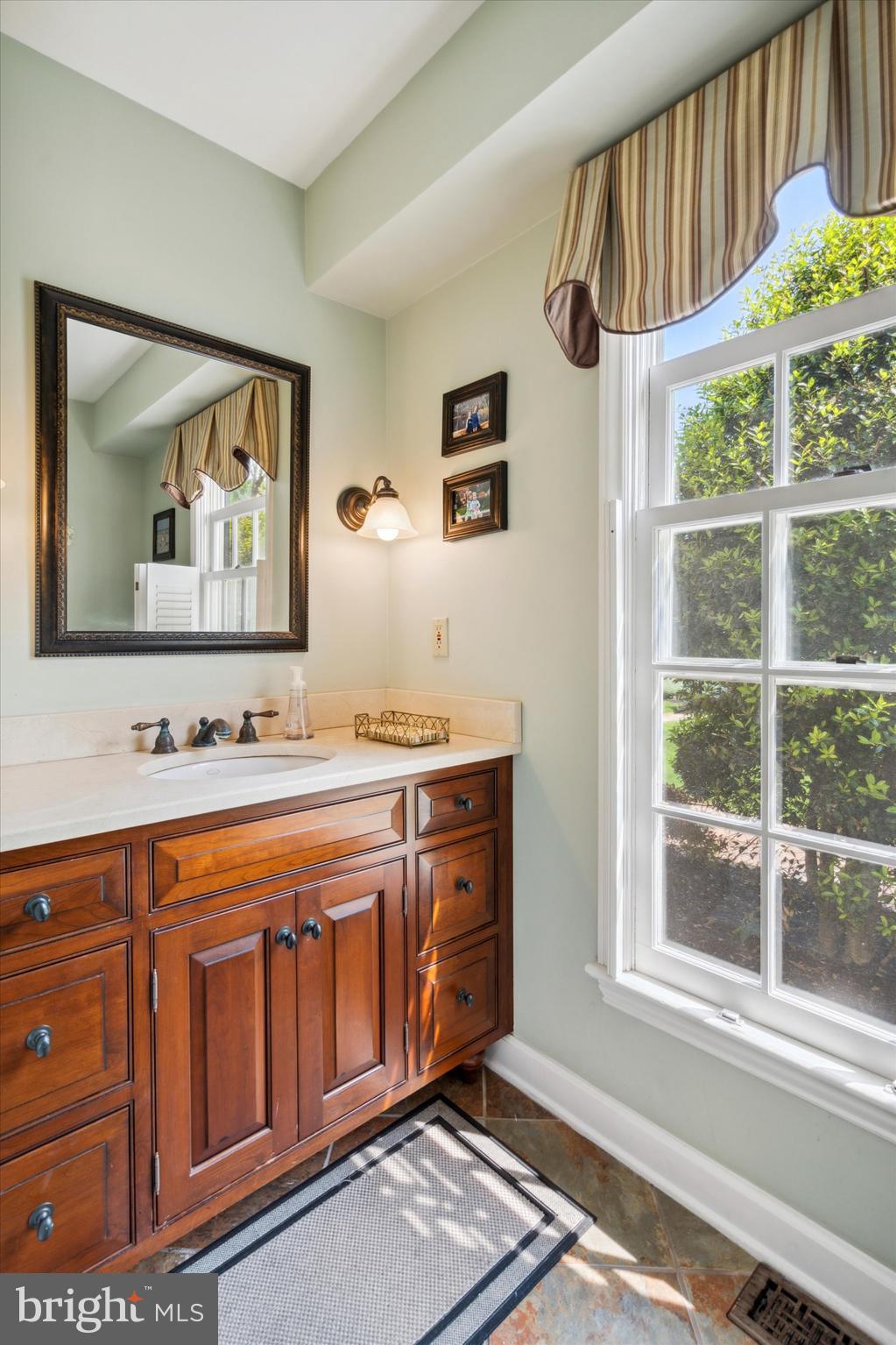 792 Avonwood Drive Wayne, PA 19087 - Photo 16 of 35 a bathroom with a sink and a large mirror next to a window