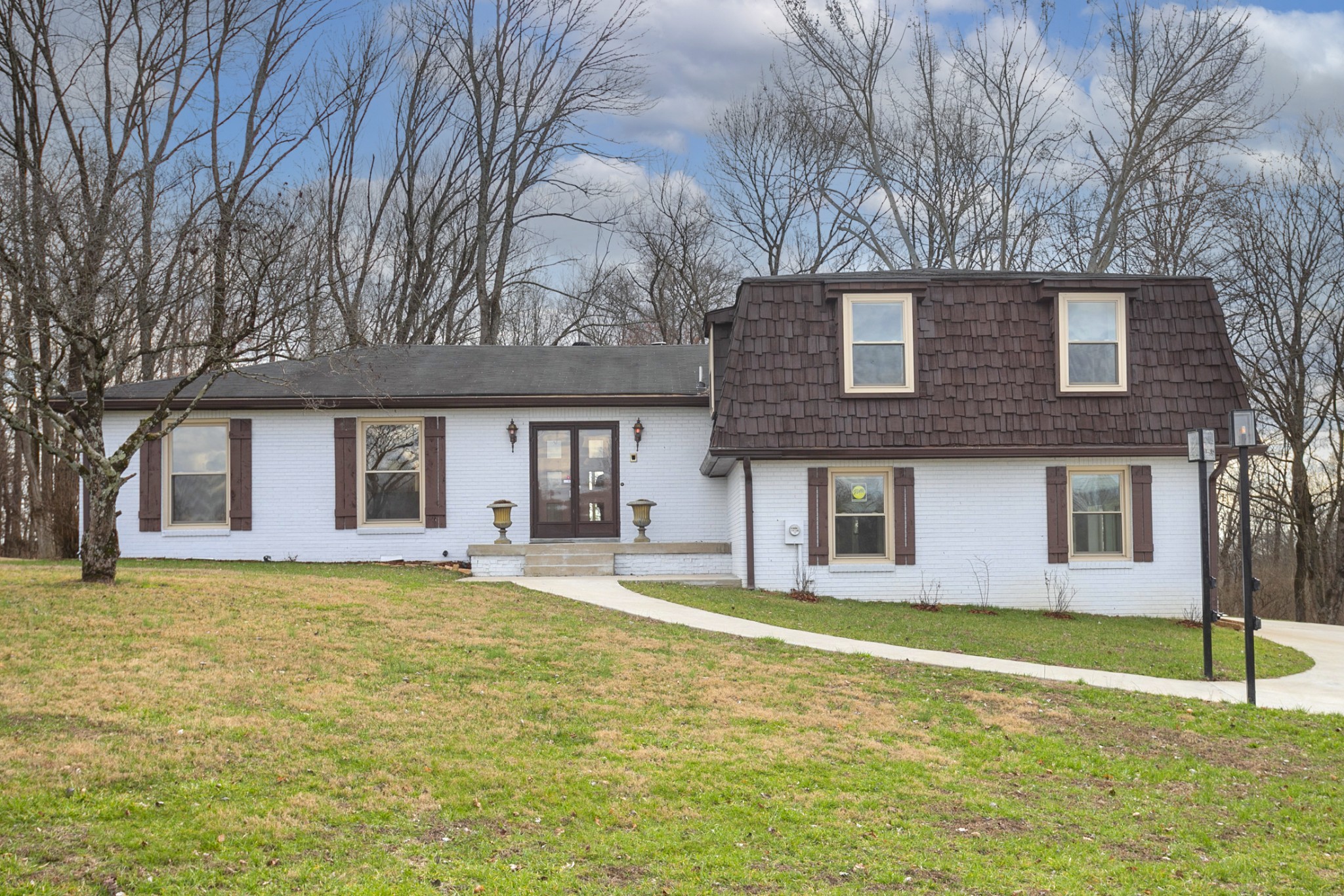 742 C Bates Road Lebanon, TN 37087 - Photo 2 of 59 a front view of a house with a garden and trees