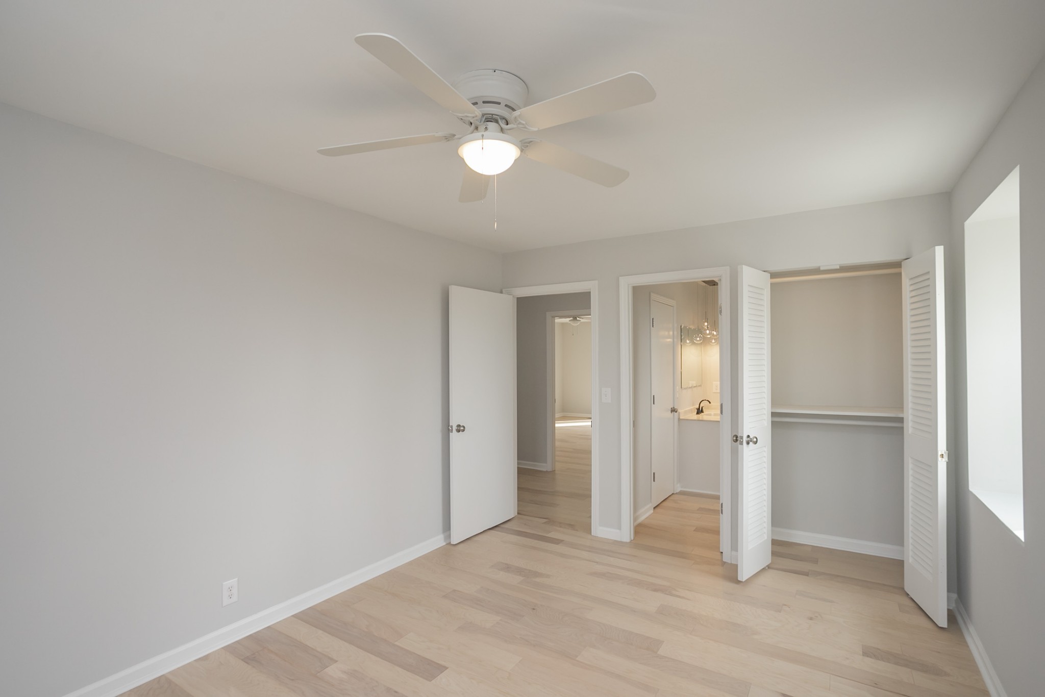 742 C Bates Road Lebanon, TN 37087 - Photo 47 of 59 a view of an empty room with wooden floor and a ceiling fan