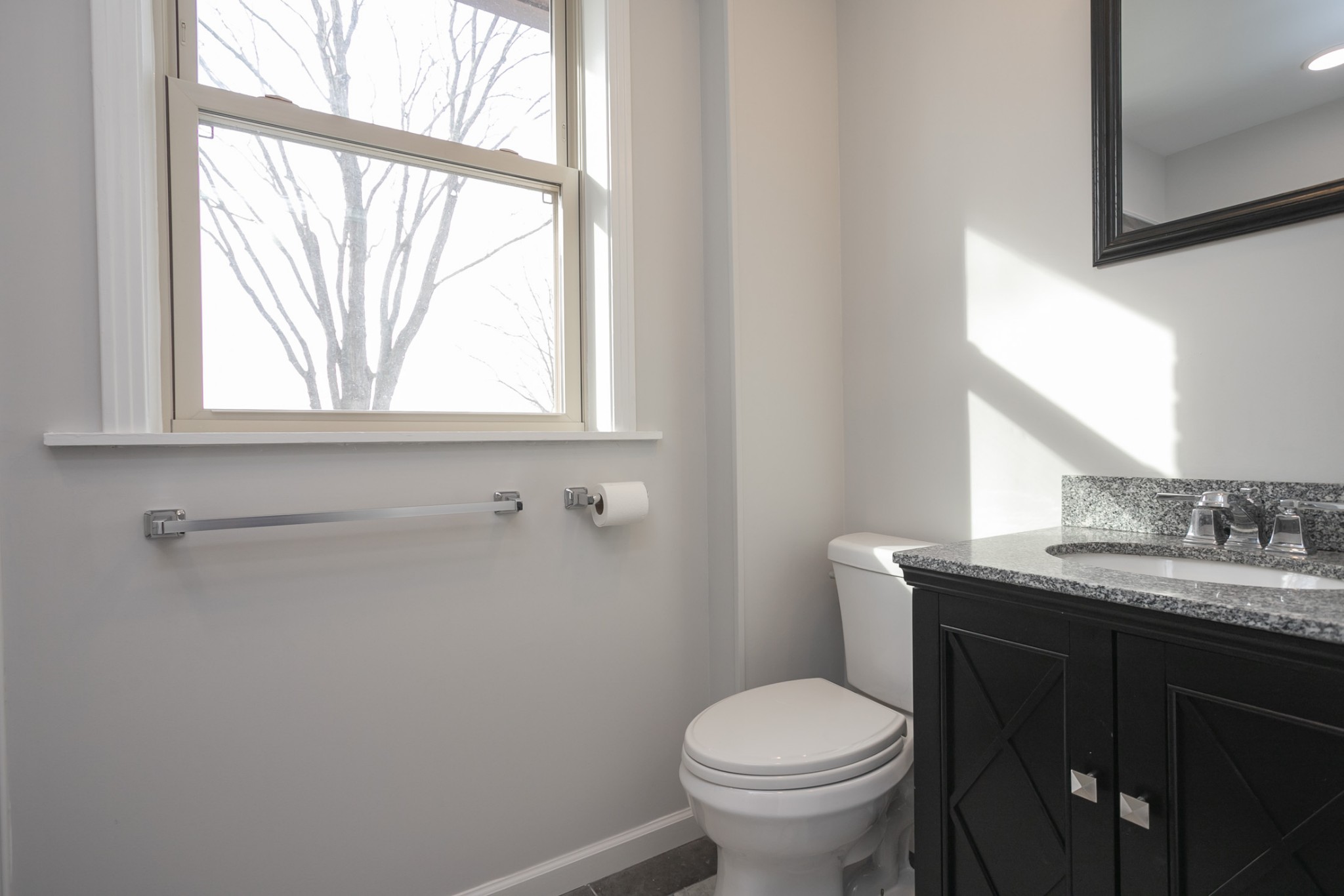 742 C Bates Road Lebanon, TN 37087 - Photo 55 of 59 a bathroom with a granite countertop toilet a sink a large mirror and a window