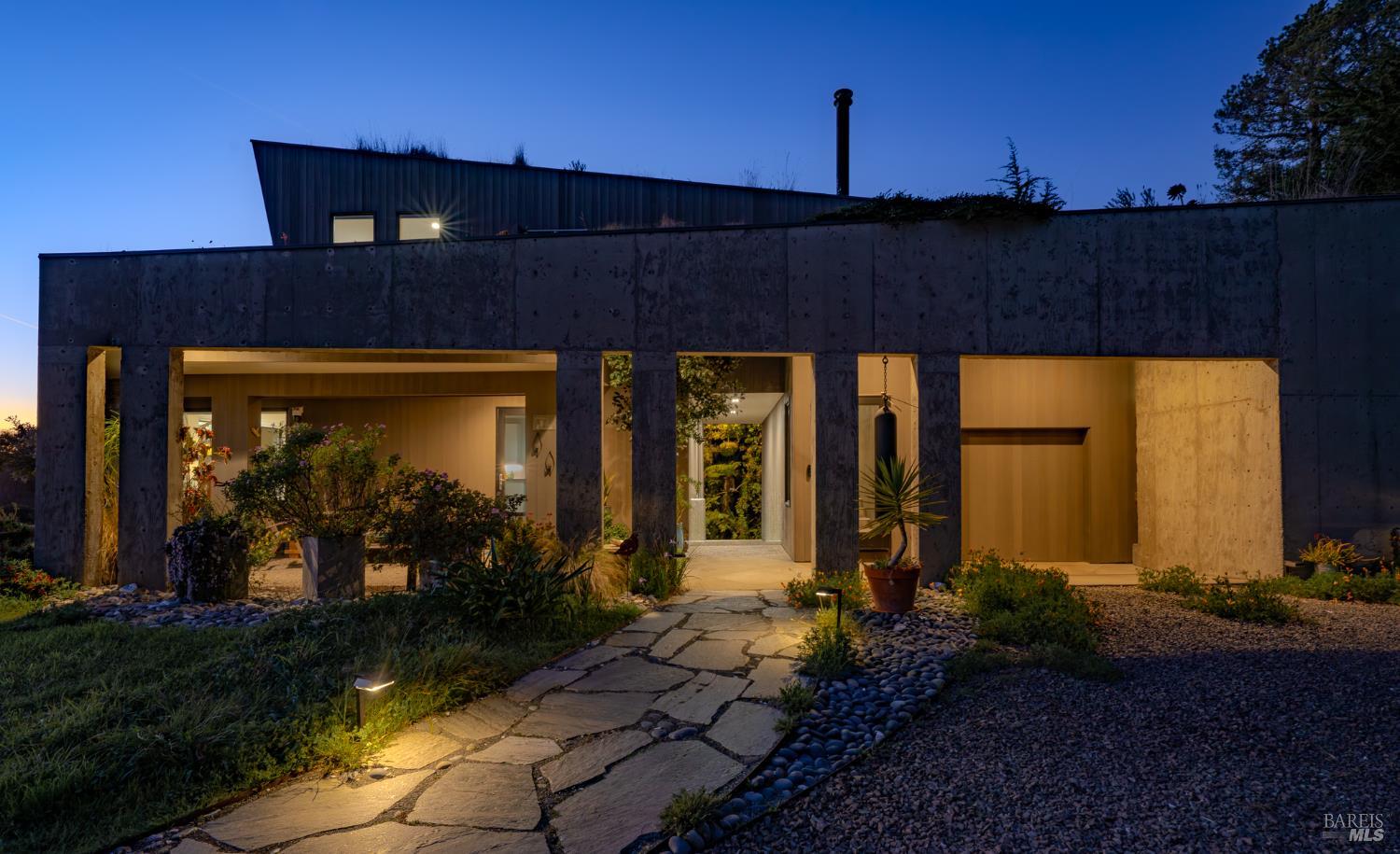 39074 Hedgegate Road The Sea Ranch, CA 95497 - Photo 15 of 38 Twilight profile highlighting the illuminated entryway path, covered patios, breezeway and modern architecture.