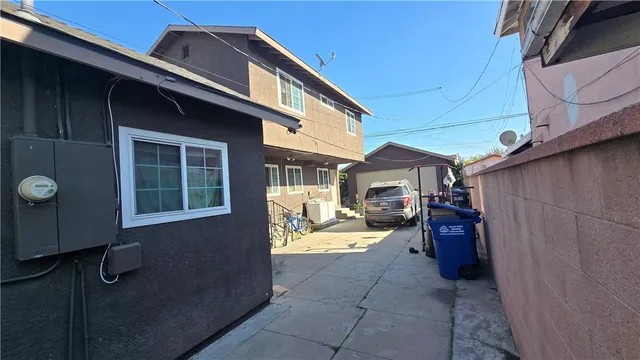 a view of a house with a patio and backyard
