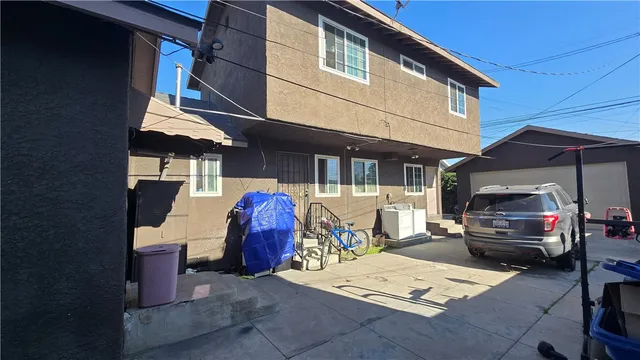 a view of a house with large space and a car parked beside it