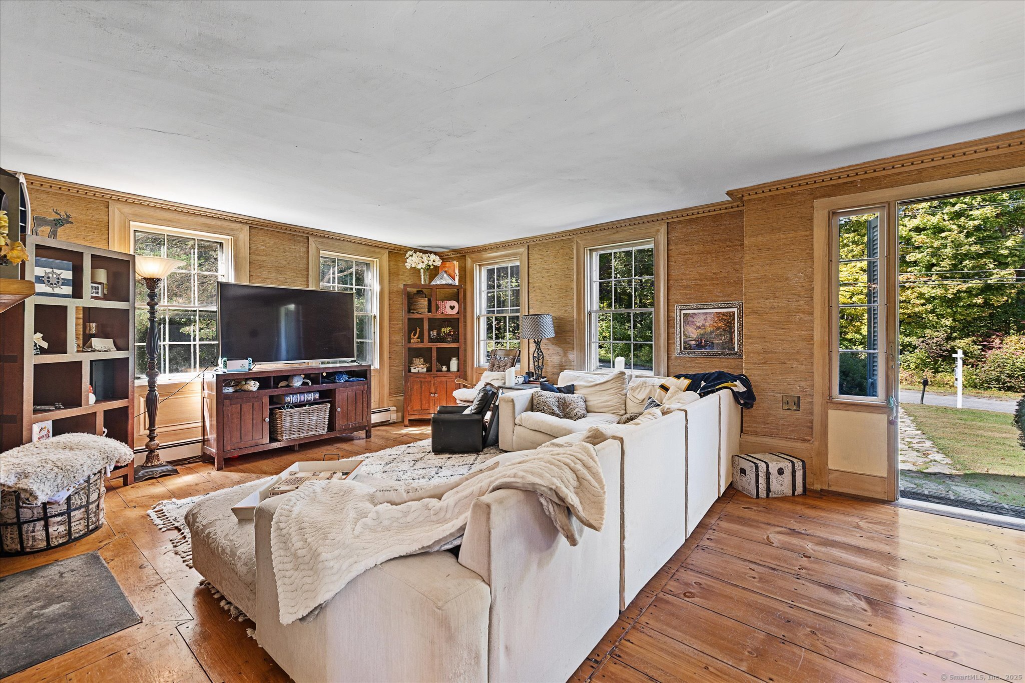 101 Child Hill Road Woodstock, CT 06281 - Photo 5 of 39 a living room with furniture a flat screen tv and a floor to ceiling window