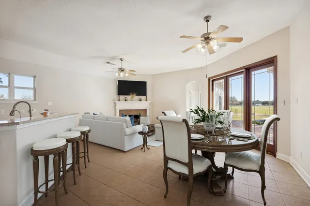 a view of a dining room with furniture and a chandelier