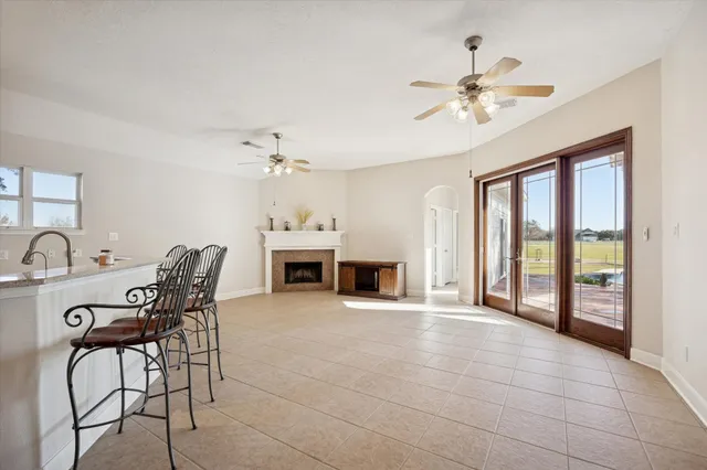 a view of a livingroom with furniture and chandelier fan