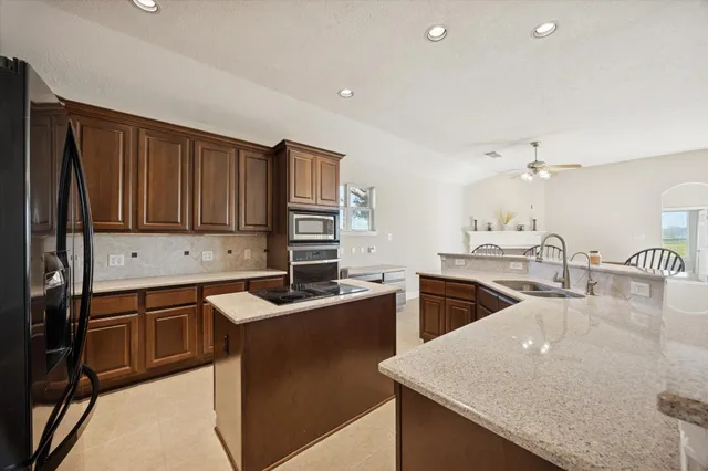 a kitchen that has a sink and a stove in it