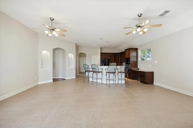 a view of a livingroom with furniture and a ceiling fan