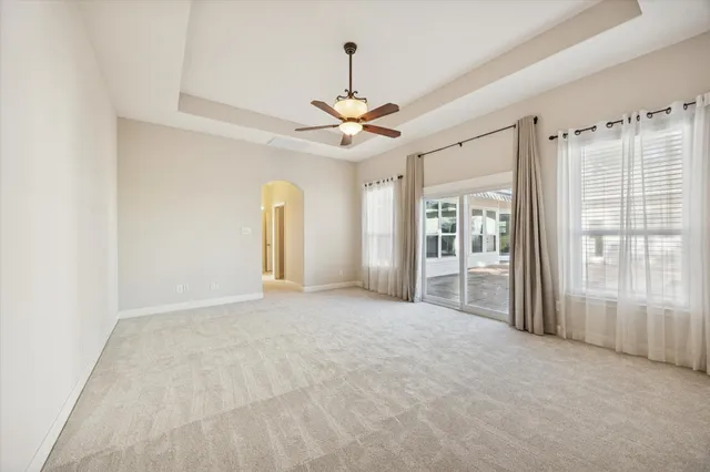 a view of a livingroom with a ceiling fan and window