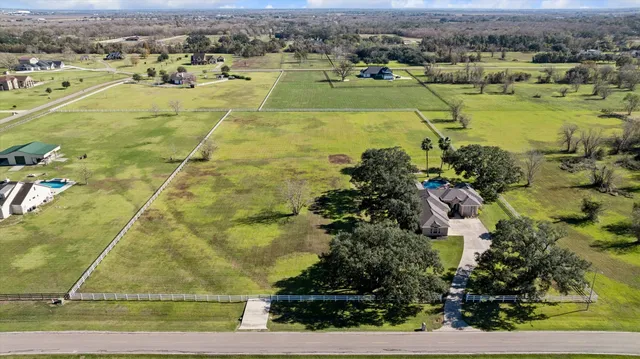 an aerial view of a houses with outdoor space