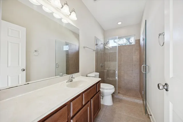 a bathroom with a double vanity sink mirror and toilet