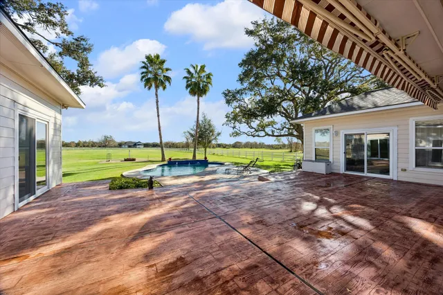 a view of a house with backyard and porch