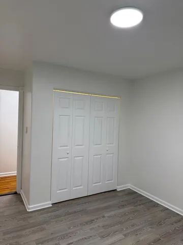 a view of an empty room and wooden floor