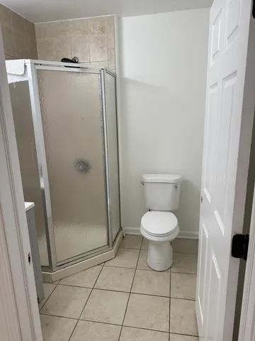 a bathroom with a toilet and a shower