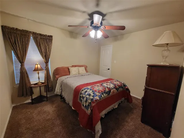 a bed sitting in a room next to a window