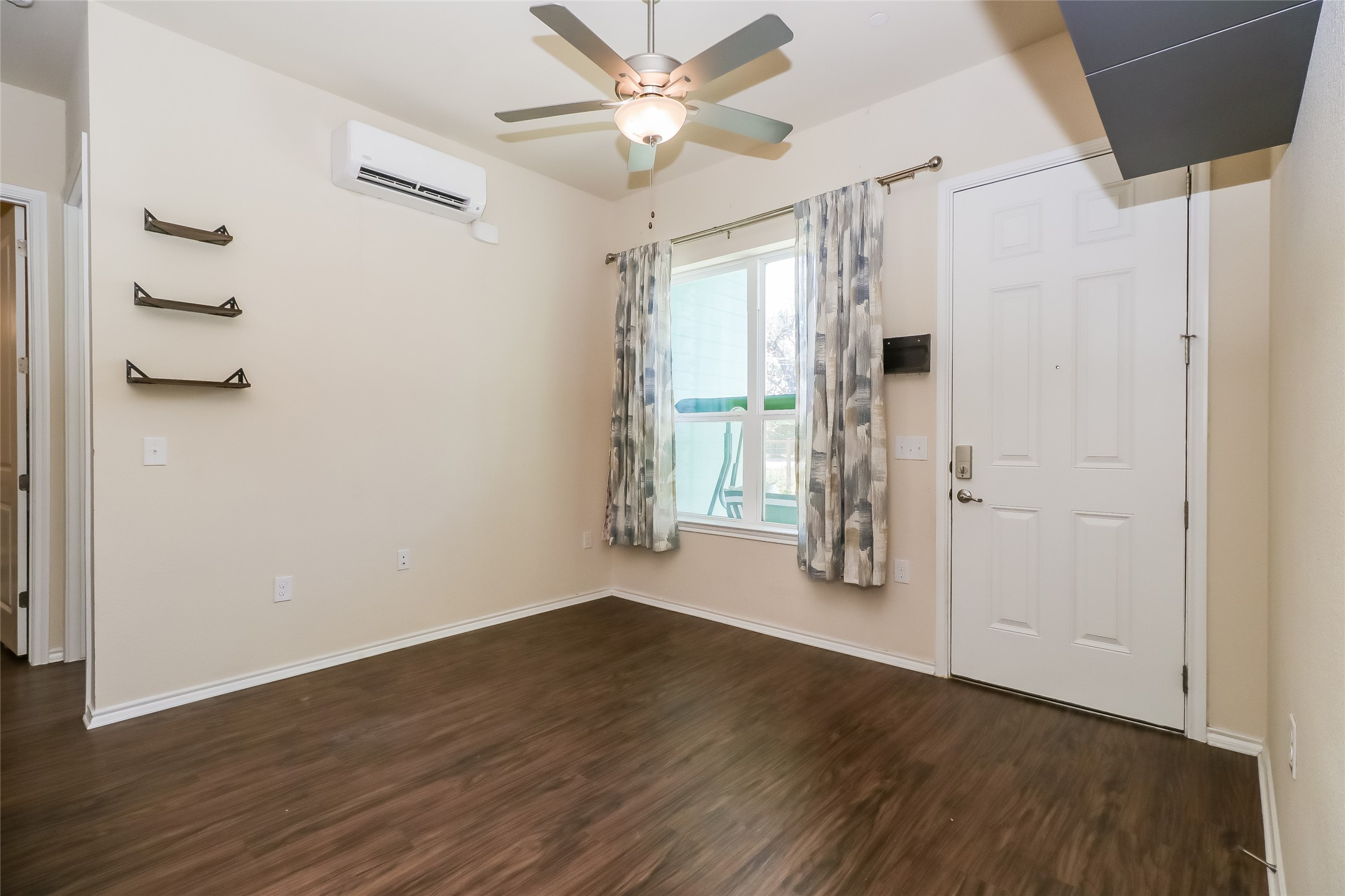 8601 West Gate Boulevard, Unit 7101 Austin, TX 78745 - Photo 4 of 16 Entryway featuring a wall mounted mini split, a ceiling fan, and dark wood-type flooring