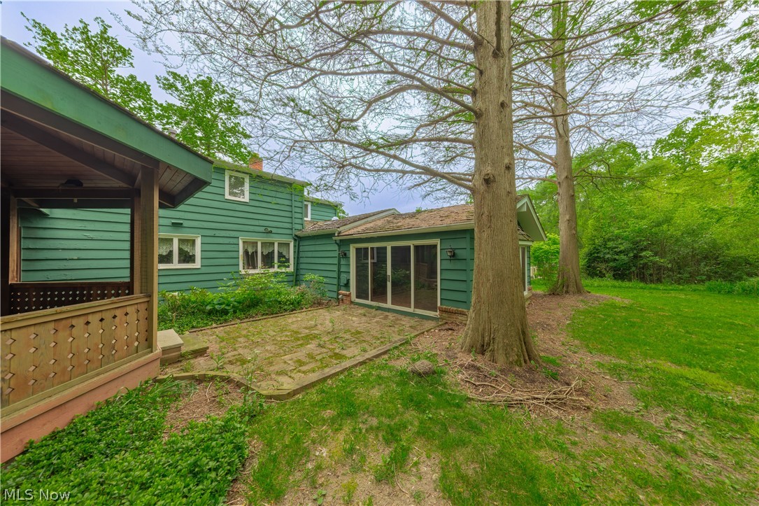 25001 Letchworth Road Beachwood, OH 44122 - Photo 46 of 50 Exterior featuring a covered porch with wooden railings, a screened-in patio, and a stone paver patio