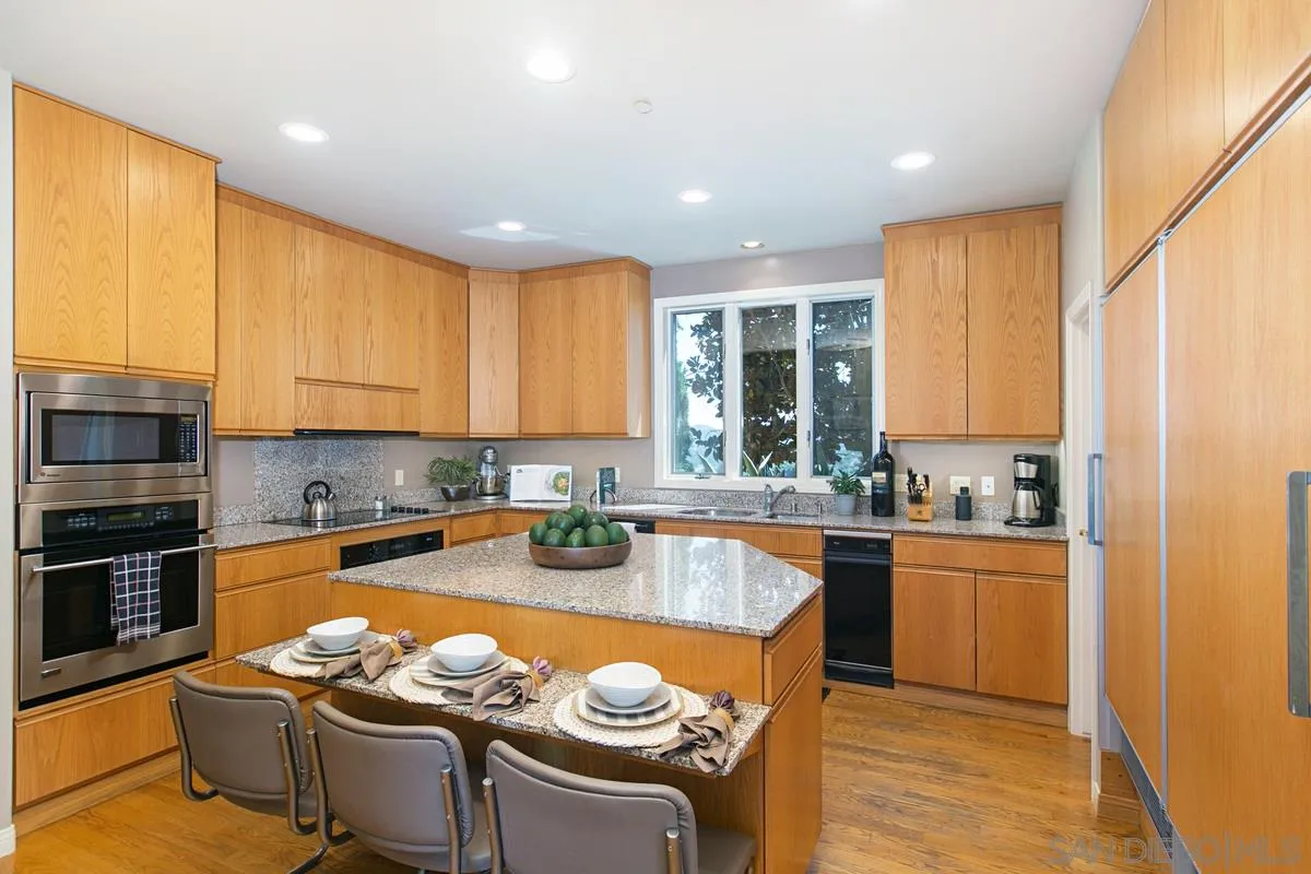 1629 Wild Acres Road Vista, CA 92084 - Photo 11 of 34 a kitchen with stainless steel appliances granite countertop a stove sink refrigerator and cabinets