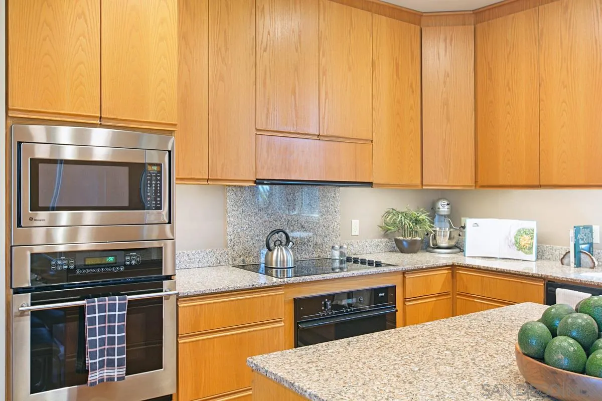 1629 Wild Acres Road Vista, CA 92084 - Photo 13 of 34 a kitchen with stainless steel appliances granite countertop a stove a sink and a microwave