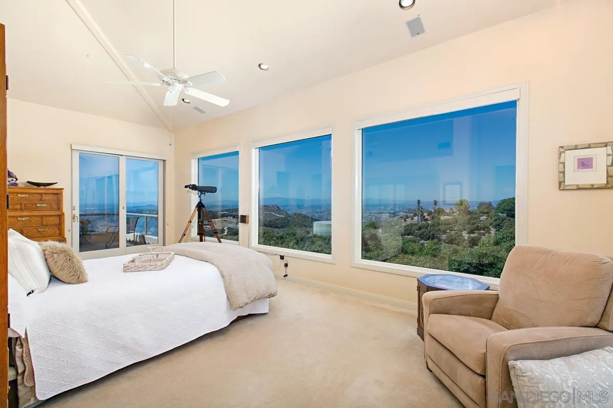 1629 Wild Acres Road Vista, CA 92084 - Photo 16 of 34 a bedroom with a bed couch and window