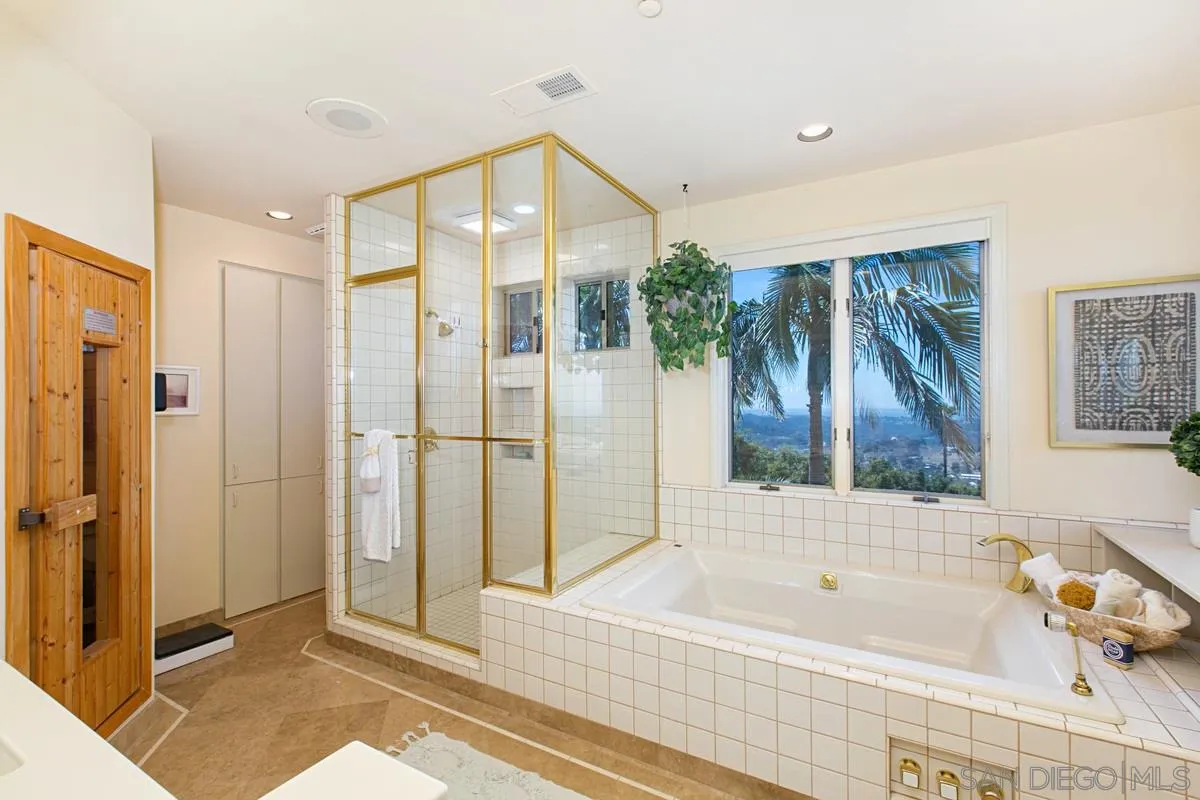 1629 Wild Acres Road Vista, CA 92084 - Photo 21 of 34 a bathroom with a bathtub and a shower