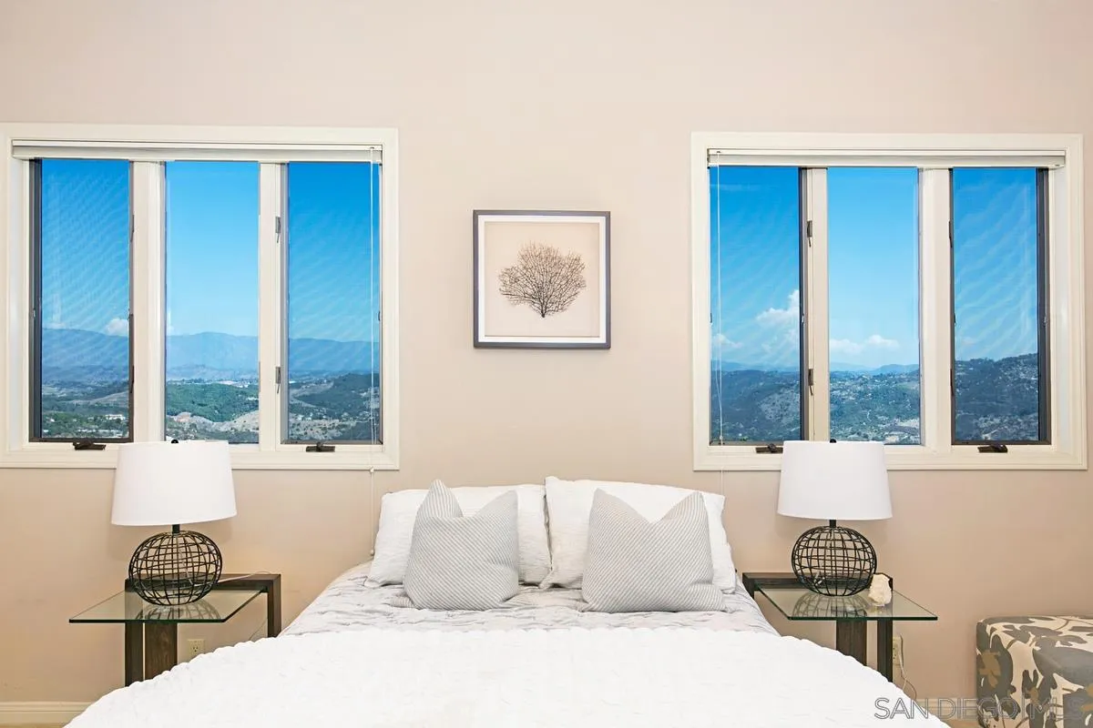 1629 Wild Acres Road Vista, CA 92084 - Photo 25 of 34 a bedroom with a large bed and a window