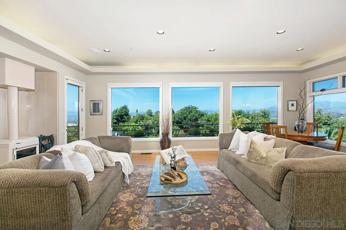 1629 Wild Acres Road Vista, CA 92084 - Photo 5 of 34 a living room with furniture floor to ceiling window and wooden floor