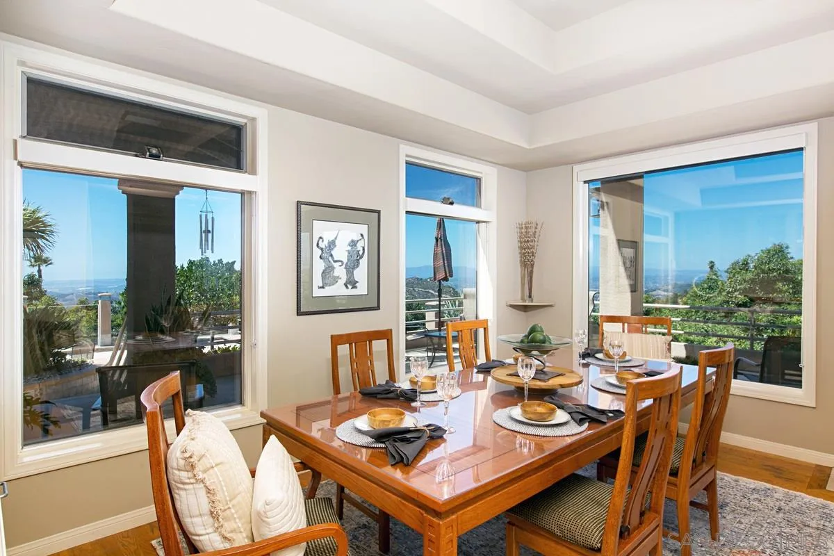 1629 Wild Acres Road Vista, CA 92084 - Photo 10 of 34 a dining room with furniture a rug and a painting on the wall