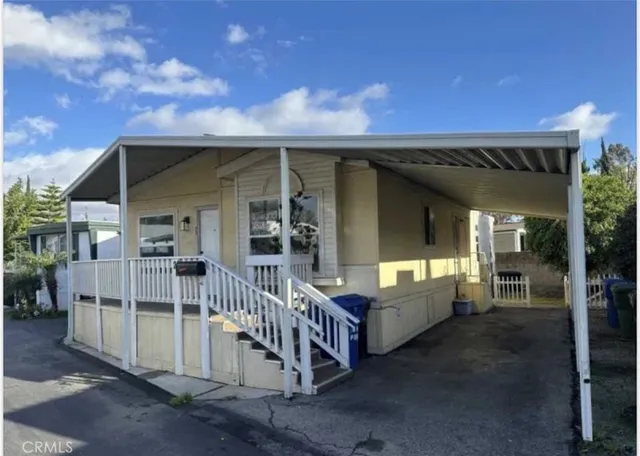 a view of a house with a porch and furniture