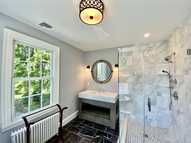 a bathroom with a sink a toilet and a shower