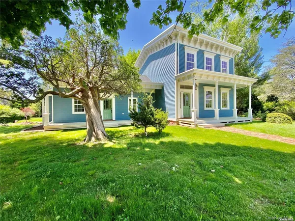 a front view of a house with swimming pool and garden